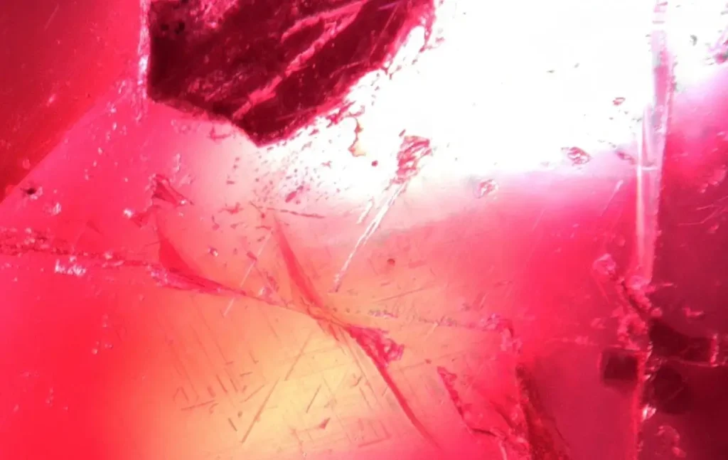 Microscopic view of fine, needle-like rutile inclusions inside a Sri Lankan ruby.