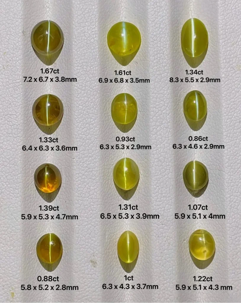 A collection of Sri Lankan chrysoberyl cat's eyes in various carat sizes showing sharp chatoyancy.