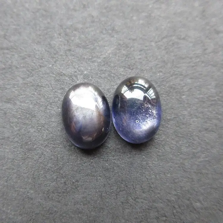 A 3.25ct pair of Sri Lankan bloodshot iolite cabochons showing both asterism and chatoyancy.