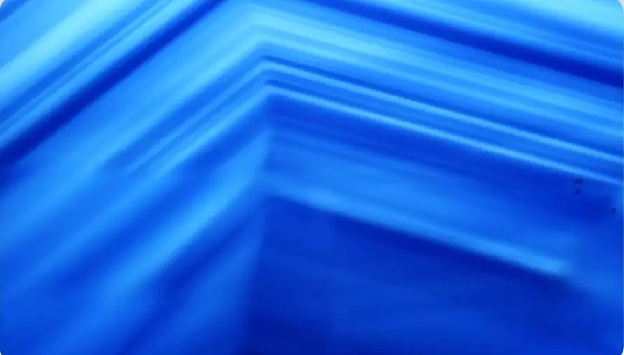Macro view of a blue gemstone crystal showing parallel, straight blue bands of color zoning.