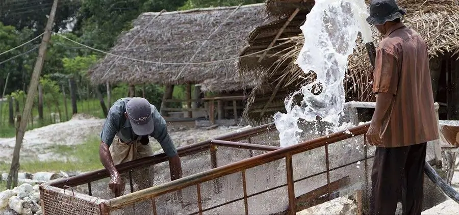 Miners extracting moonstone-bearing gravel from a traditional pit mine in Sri Lanka.