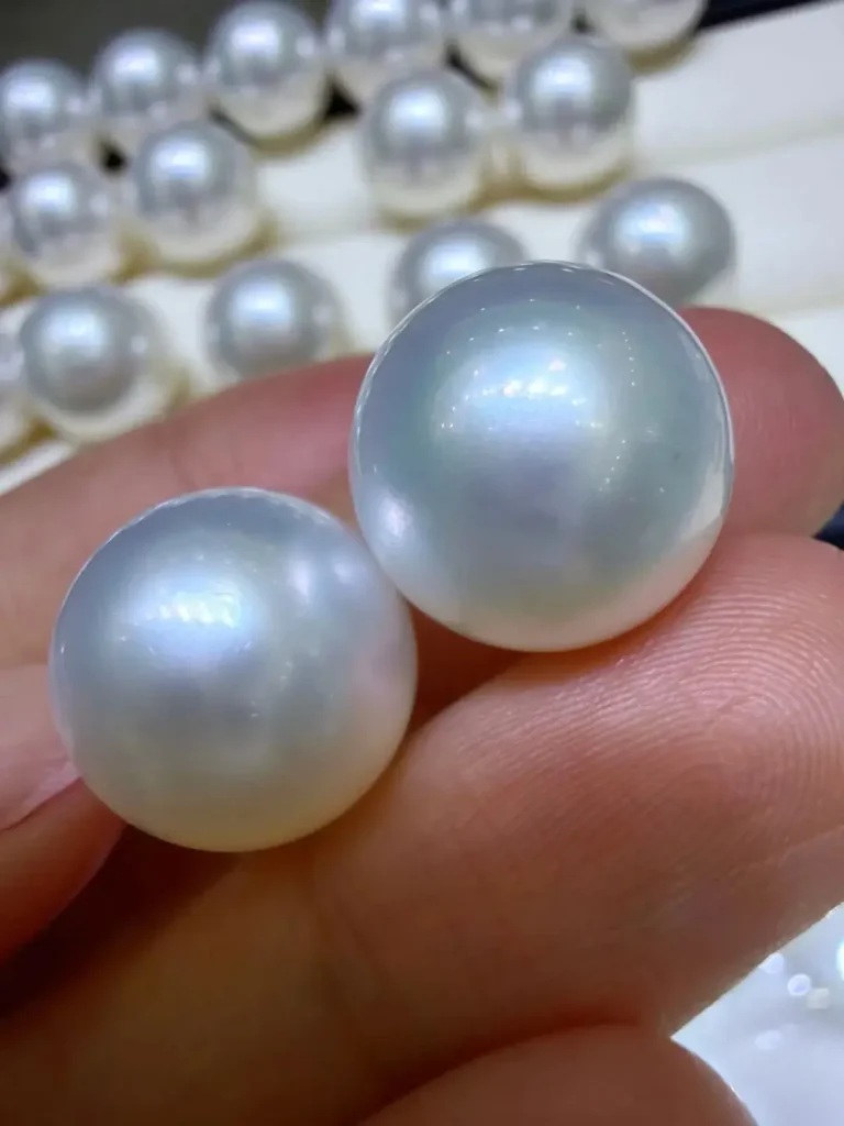 Two 13.4mm Australian South Sea pearls with a pure white body and intense, satiny metallic luster.