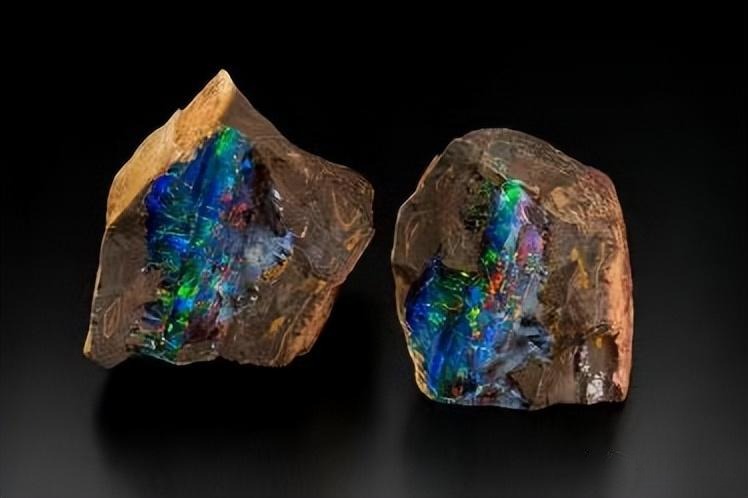 Two Australia gemstones—boulder opals from Queensland—showing vibrant opal veins in ironstone.