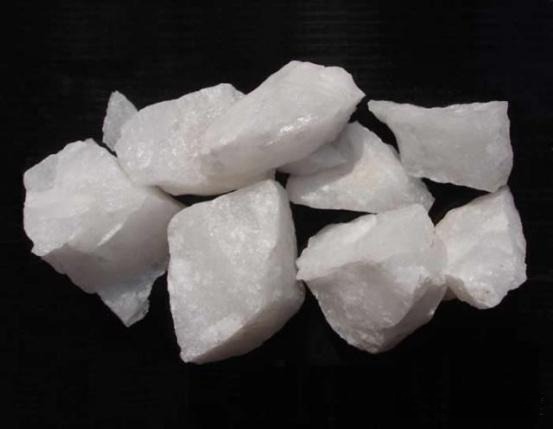 Multiple raw white quartzite rocks with a granular texture and bright crystalline luster.