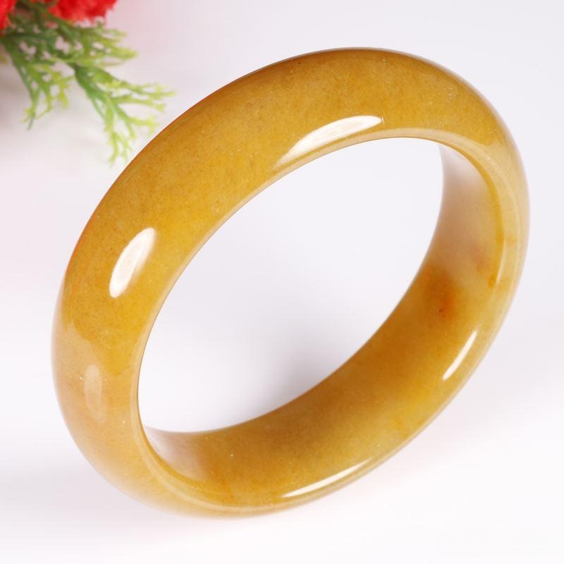 A yellow Jinsi jade bracelet with visible internal grain and cloud-like veins.