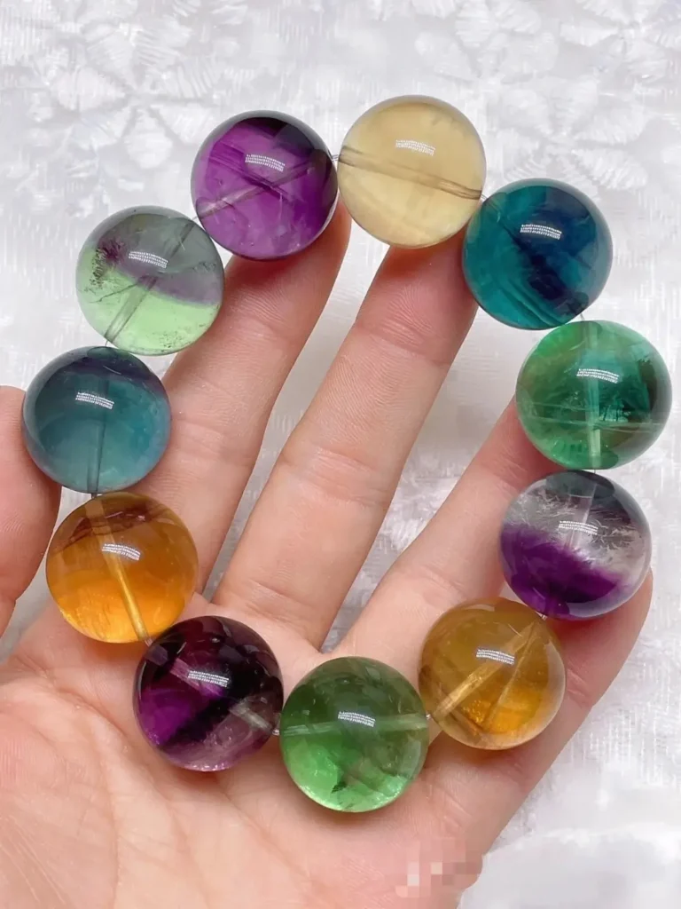 A 20mm Rainbow Fluorite bracelet featuring vibrant macaron purple and green translucent beads.