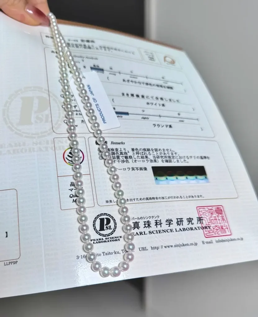 A 5.0-5.5mm Sairin Akoya pearl necklace with a Japan Pearl Science Laboratory grading report.