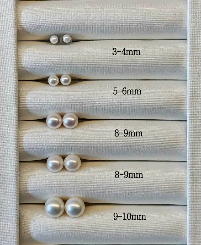 A comparative range of stud earrings from 3mm to 9mm on an ear model.