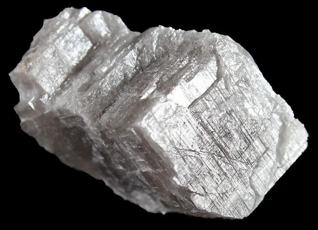 Close-up of a raw Anhydrite mineral specimen, showcasing its light blue, crystalline structure.