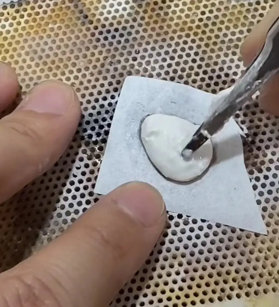 An artisan shaping a clay inner mold as a foundation for three-dimensional gold filigree.