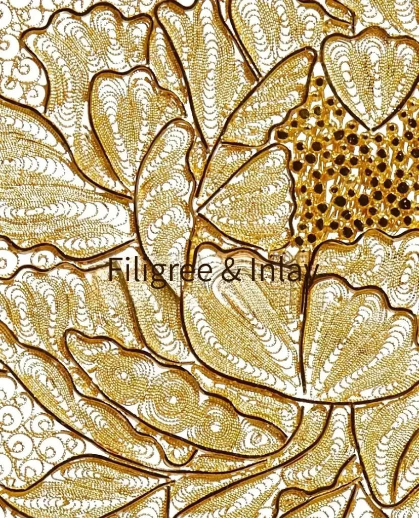 A completed gold filigree and inlay hairpiece featuring intricate wire patterns and set gemstones.