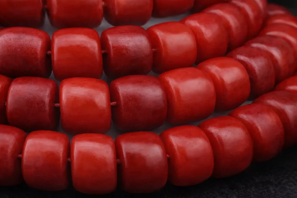 Dyed camel bone bead showing characteristic Haversian canal pores and coarse fiber texture.