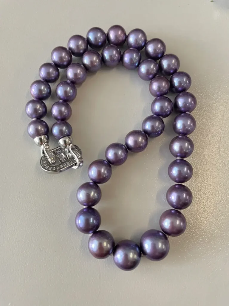 Strand of dyed violet Edison pearls with unnaturally uniform saturation.