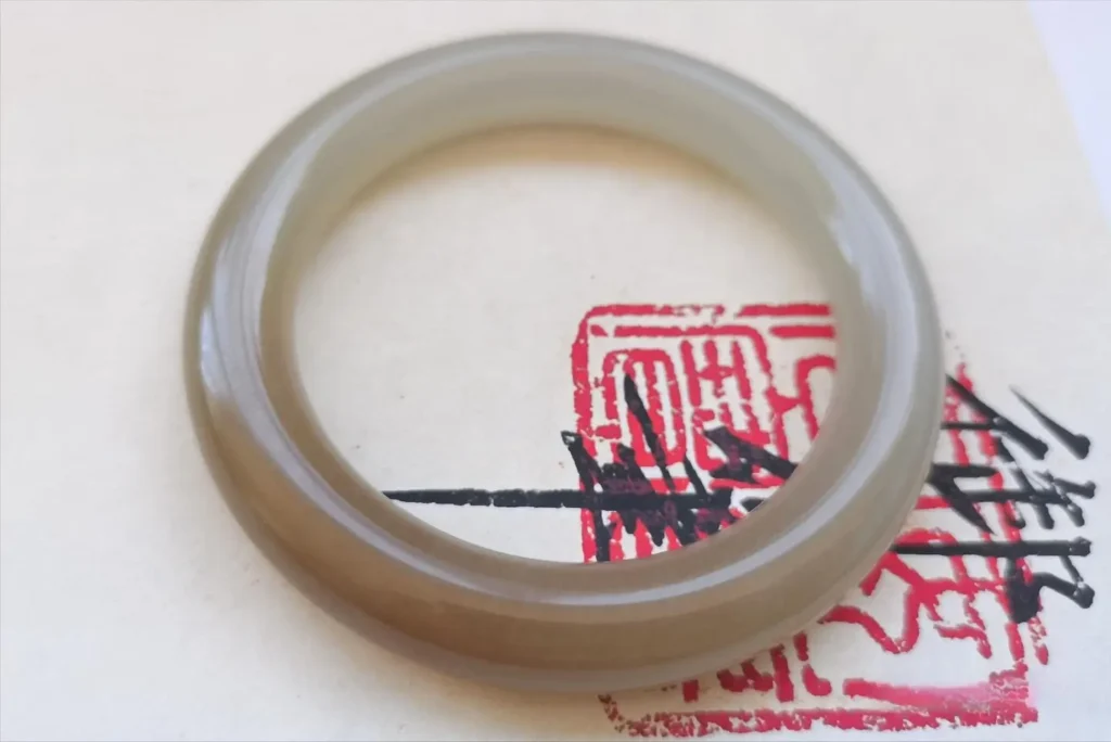 Polished Anhydrite bangle, a high-end fake Nephrite jade with a creamy Sugar-White appearance.