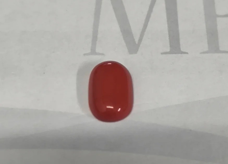 Dyed glass (Liuli) coral imitation showing characteristic internal gas bubbles and conchoidal fracture.