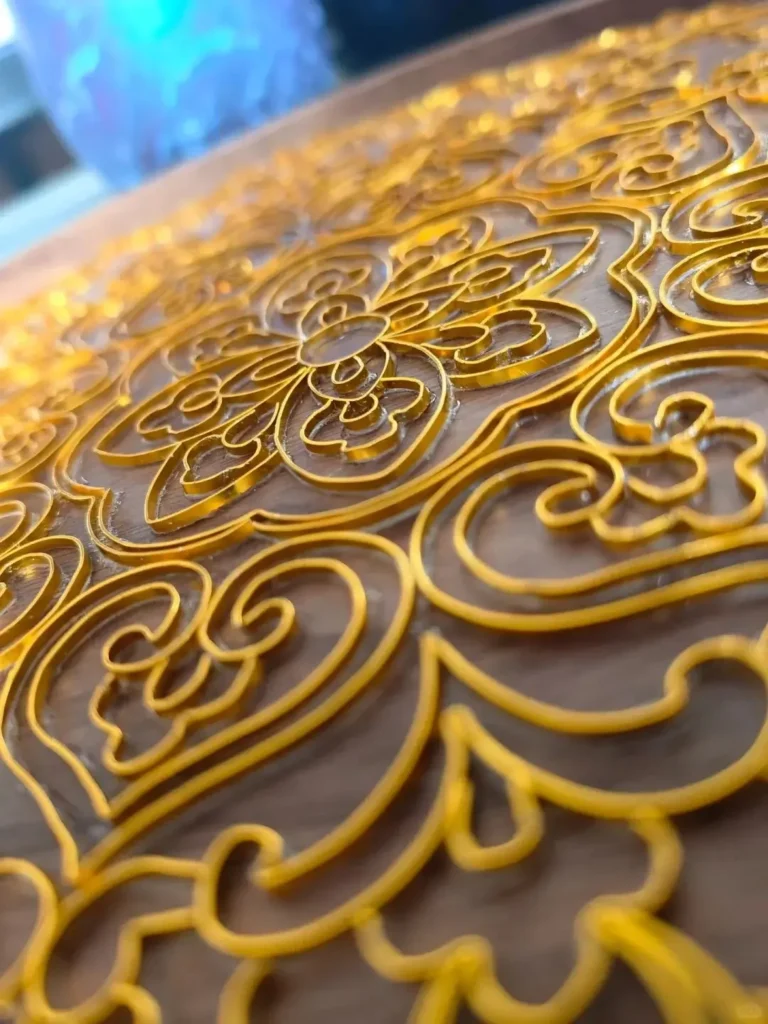 Macro view of diverse gold filigree floral motifs formed by nipping and pinching techniques.