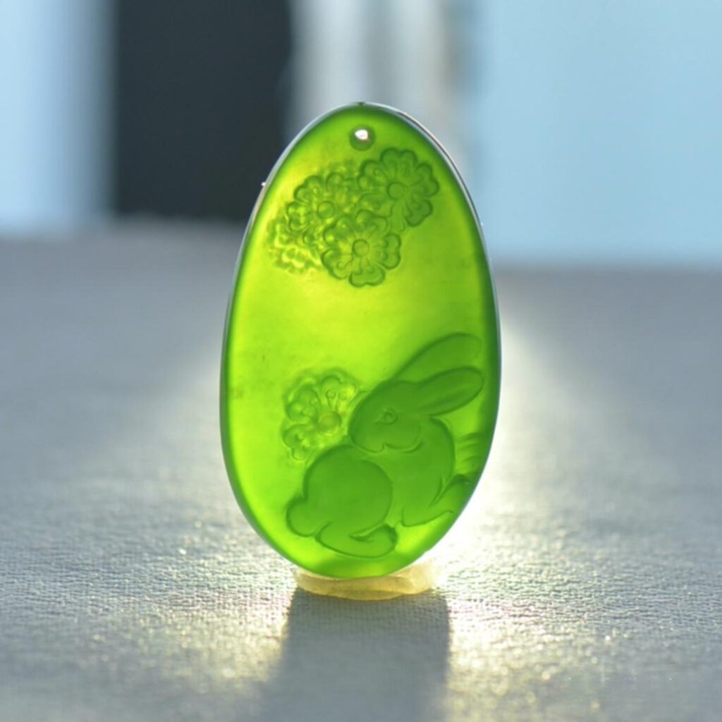 Translucent Icy-Base green Nephrite jade pendant carved in the shape of a rabbit.
