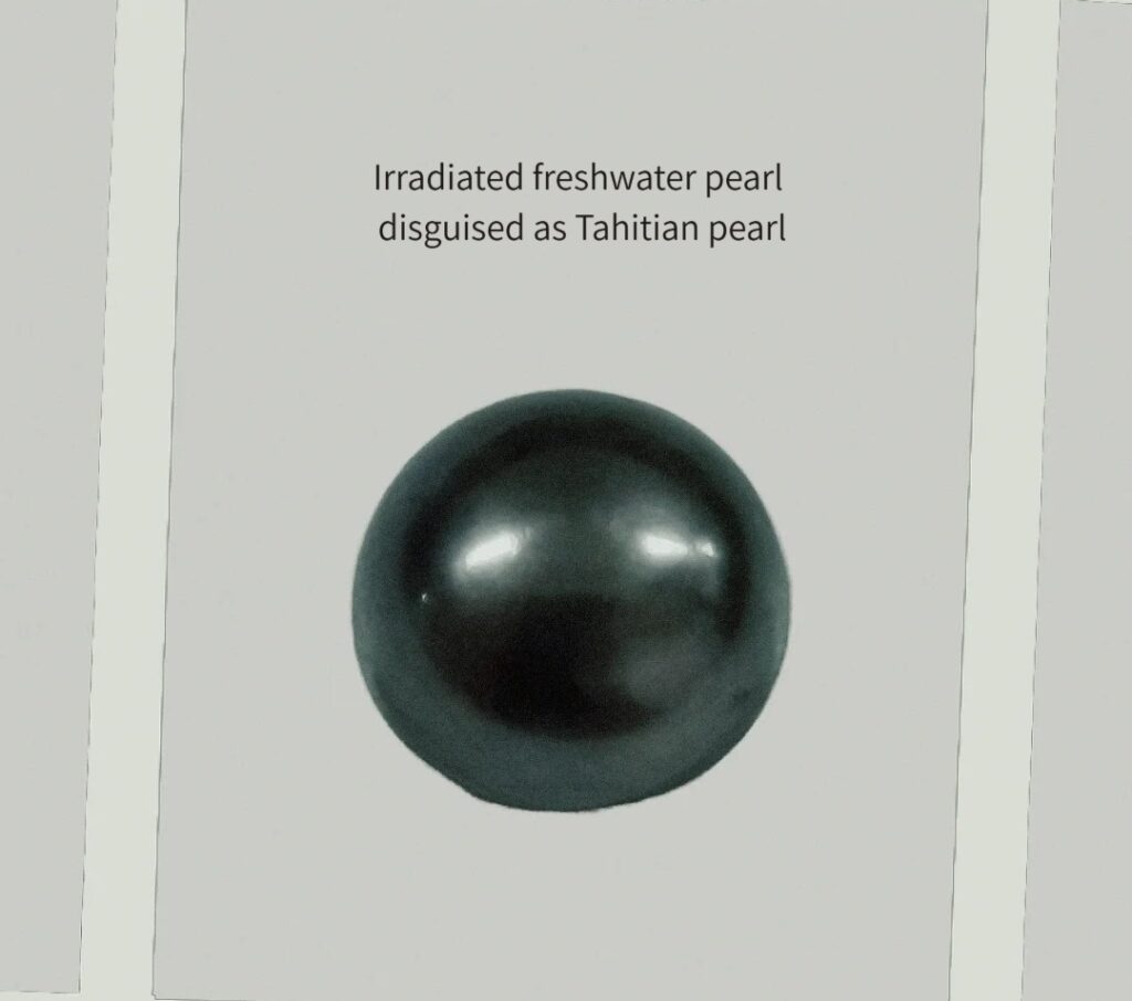 Macro view of an irradiated freshwater pearl imitating a Tahitian black pearl.