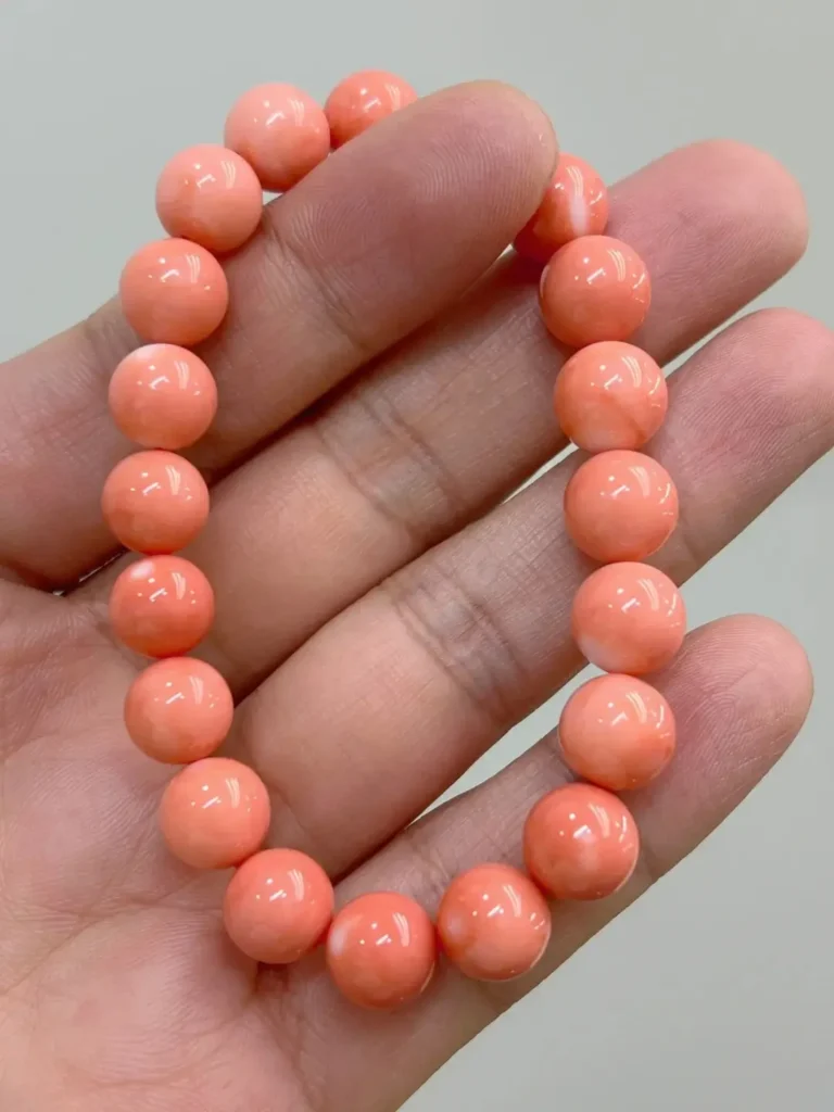 A 9-10mm natural Angel Skin Momo coral bead bracelet with delicate pink tones and fine texture.