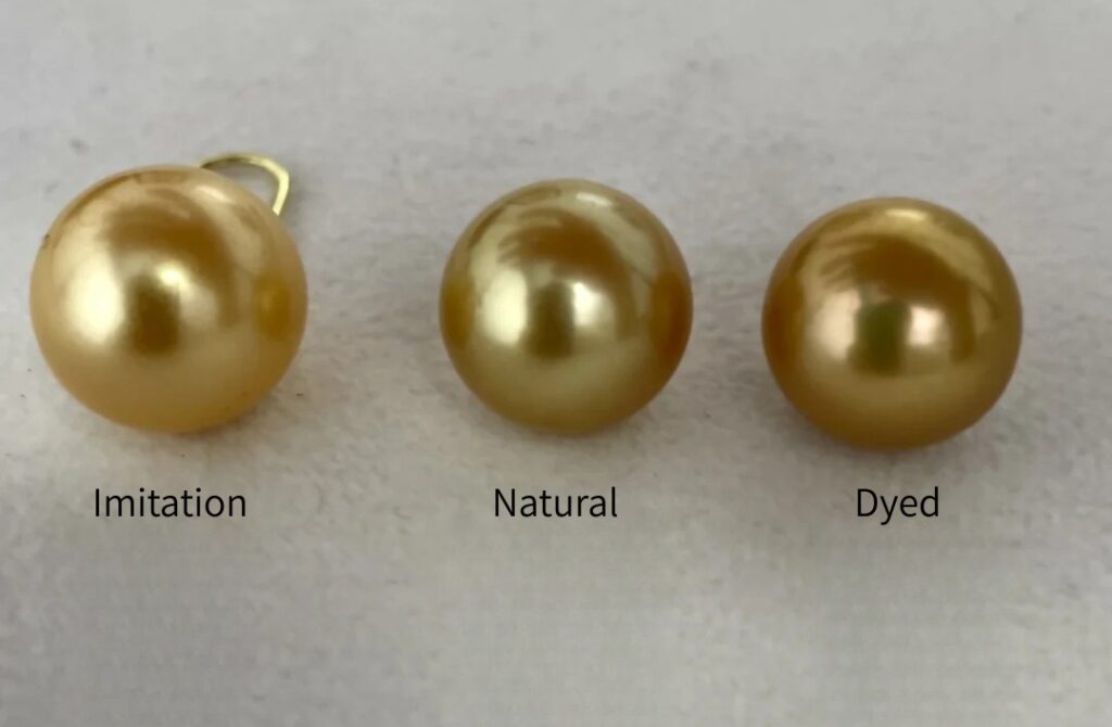 Comparison of three golden pearls: imitation, natural color, and dyed treatment.