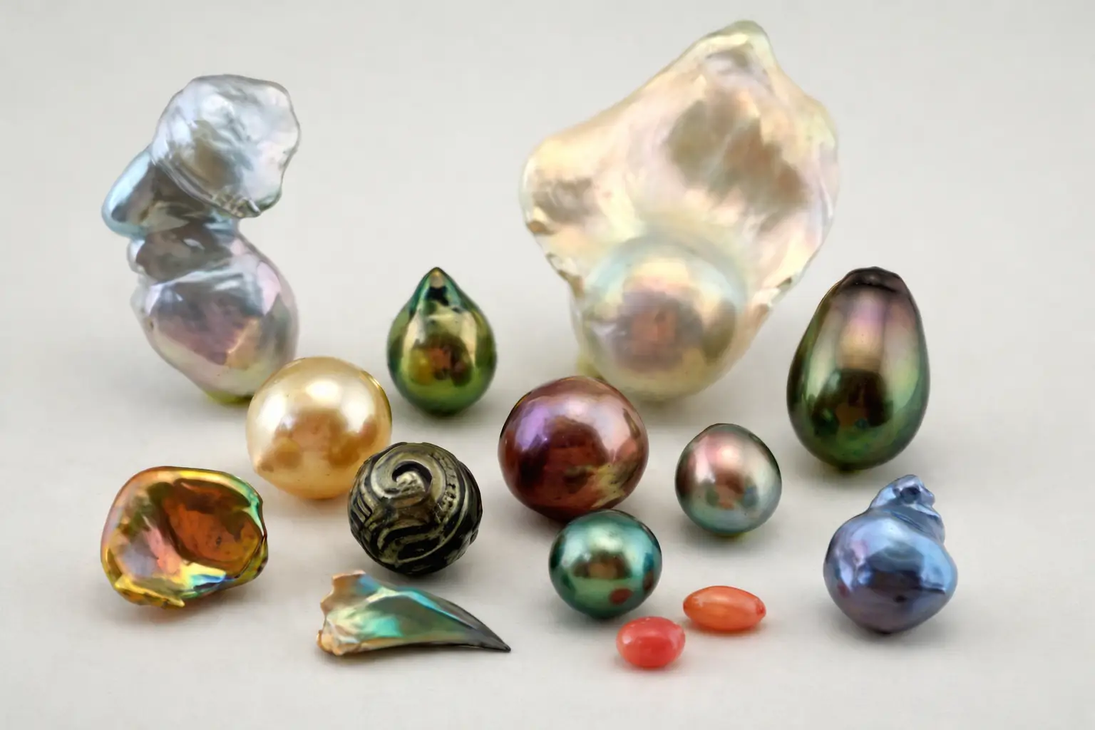 A diverse collection of natural pearls across white, pink, gold, black, and multi-color series.