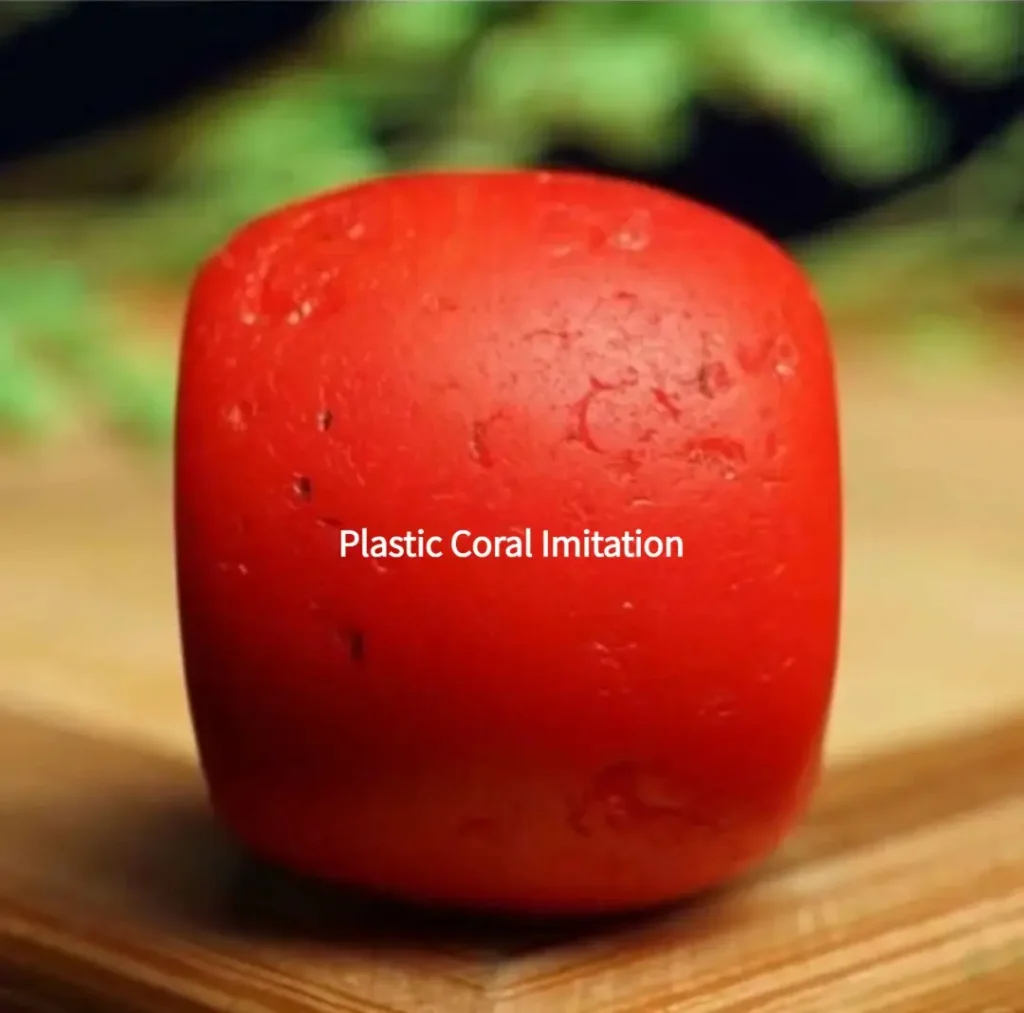 Plastic coral imitation bead showing uniform texture and lack of organic growth markers.