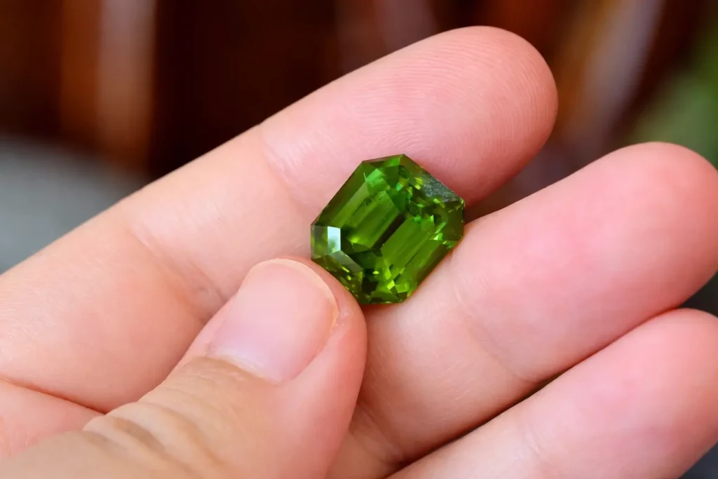 An 18.9-carat premium natural faceted peridot from Myanmar with exceptional vivid green hue.