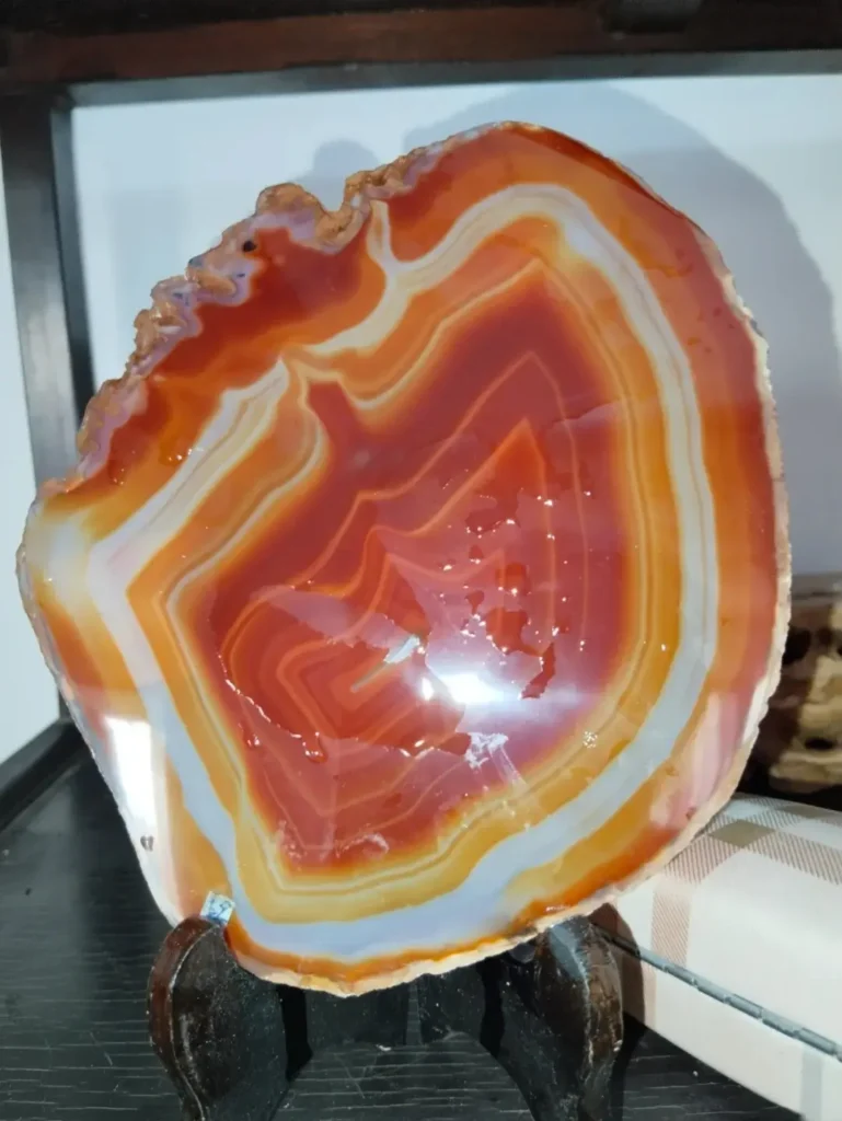 Raw silk-banded stone featuring alternating layers of reddish-brown and white chalcedony.