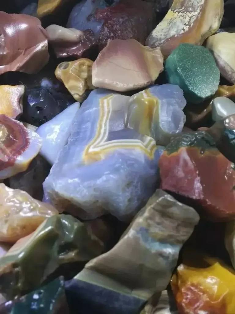 Assorted raw Alashan Agate nodules showing their natural, unpolished chalcedony texture.