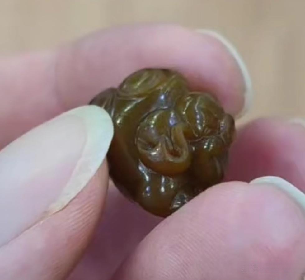 Small Xiuyan Jade carving with a natural-looking brown skin, mimicking a Sugar Nephrite seed.