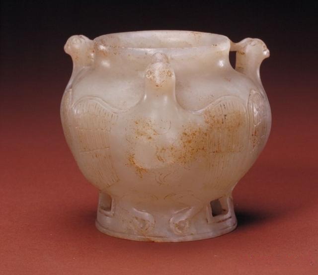 Tang Dynasty white nephrite jade jar with three handles and a celestial rooster (Tianji) motif.