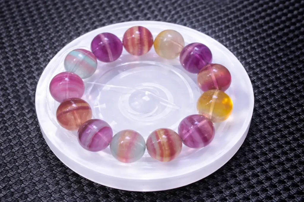 A high-quality purple fluorite bracelet featuring translucent beads with deep violet hues.