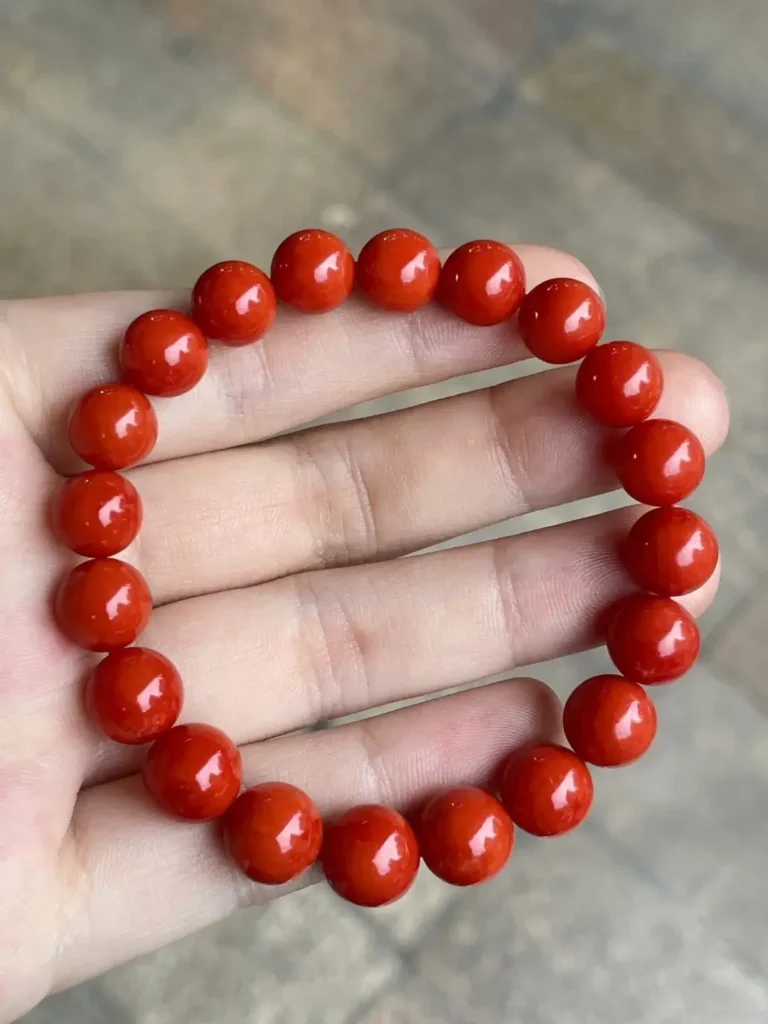 A vibrant red Sardinia coral bead bracelet featuring a clean, uniform color and consistency.