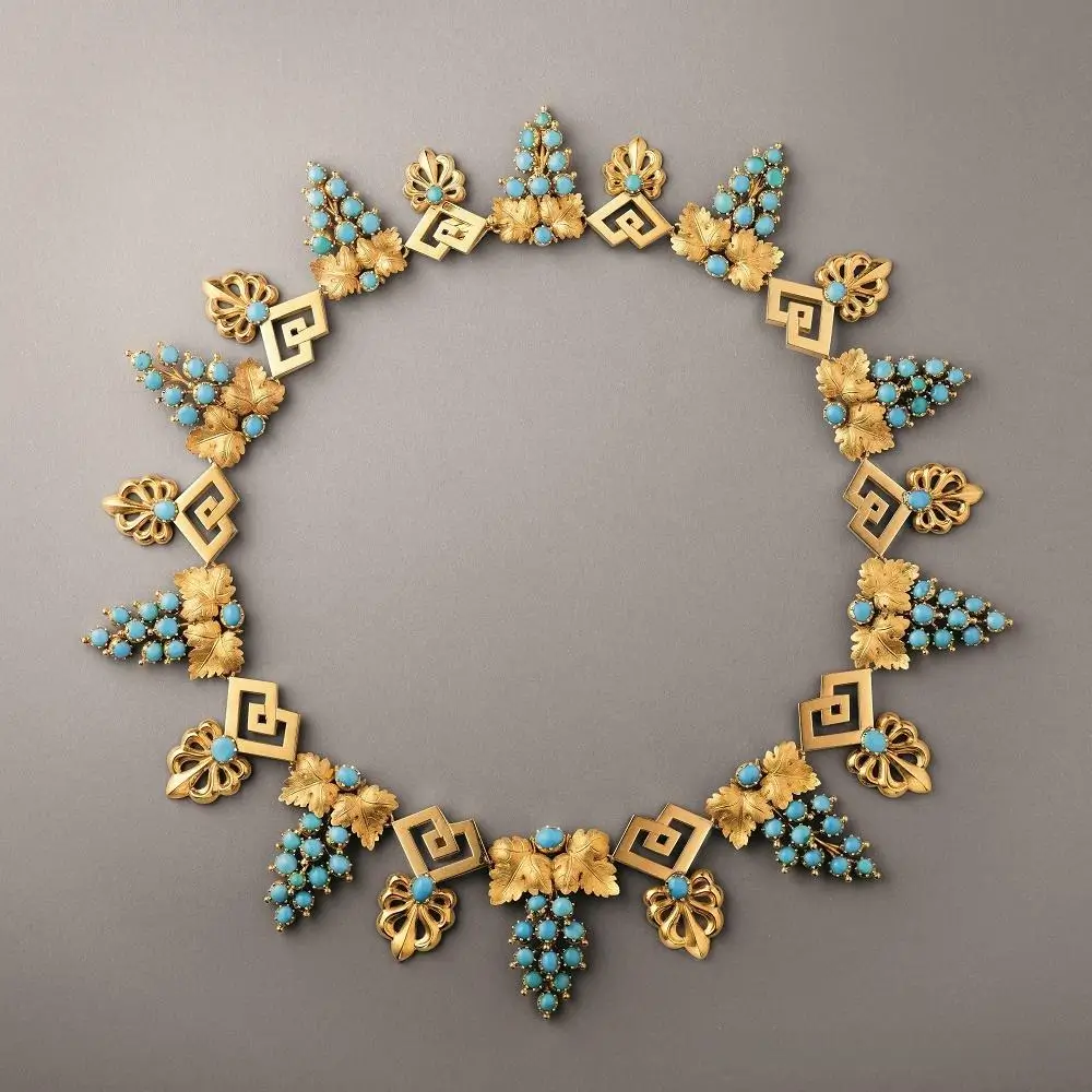 An 1825 gold necklace by Chaumet, featuring clusters of small, matrix-free turquoise cabochons.