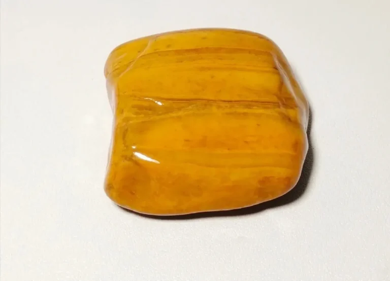 A solid yellow Jiangxi Yellow Wax Stone with a hard, waxy exterior and smooth surface.