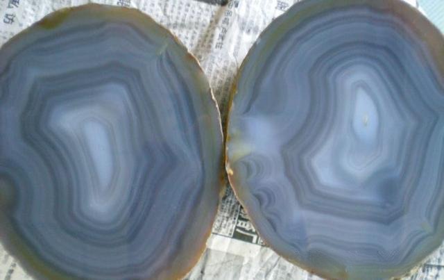 A polished cross-section of Jiangxi Agate showing vibrant yellow, red, and blue silk-like bands.