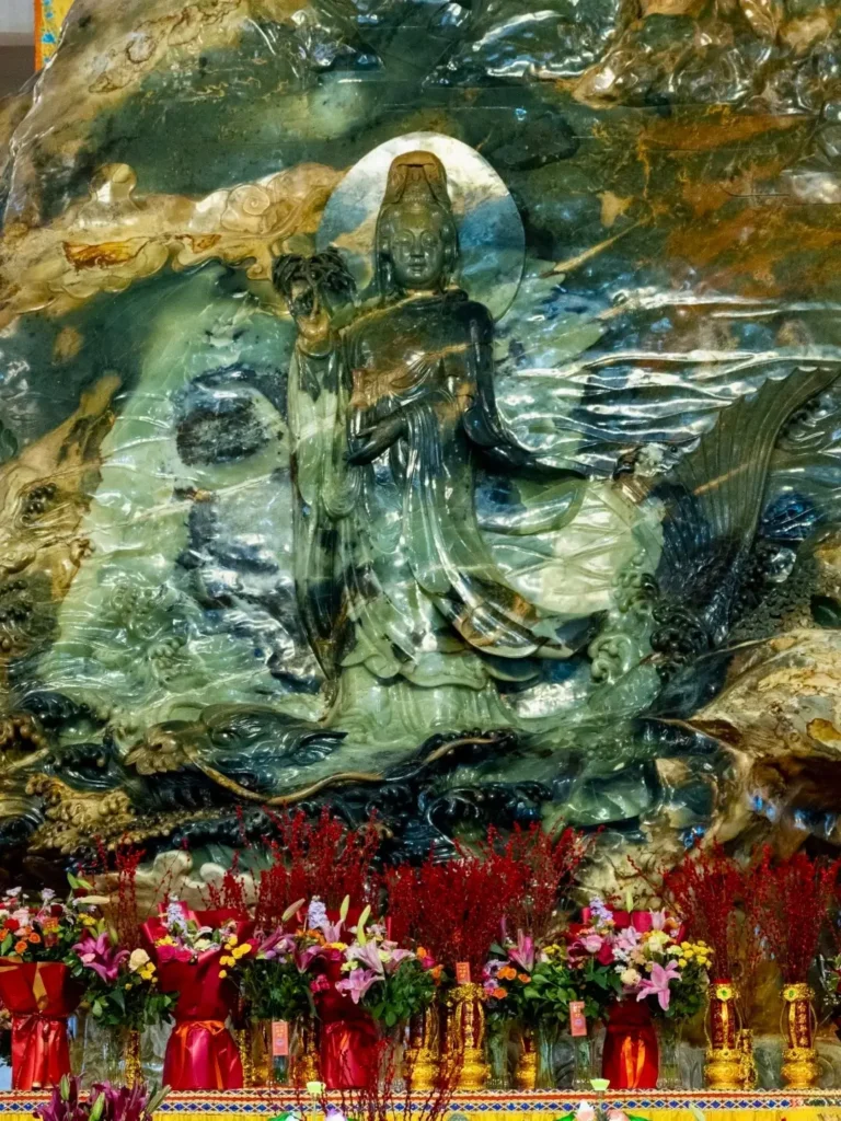 The Guanyin Crossing the Sea side of the 260.76-ton Xiuyan jade Buddha monolith in Anshan.