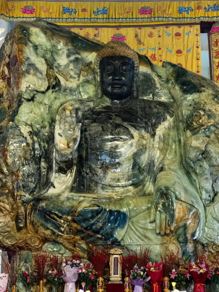 The Sakyamuni side of the world's largest jade Buddha, carved from a 260-ton Xiuyan jade block.