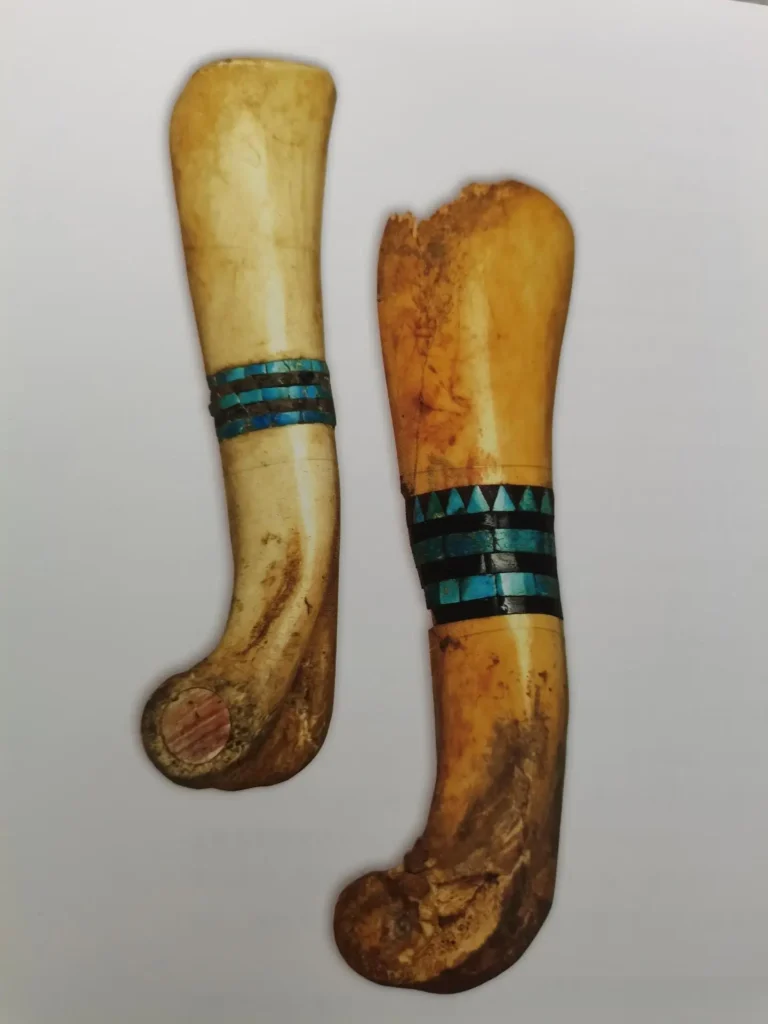 15cm bone artifacts inlaid with turquoise and jet mosaics, discovered at Chaco Canyon in 1896.
