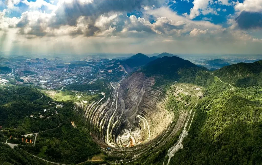 Aerial view of Hubei Daye Iron Mine, Asia's largest open pit with a massive terraced structure.