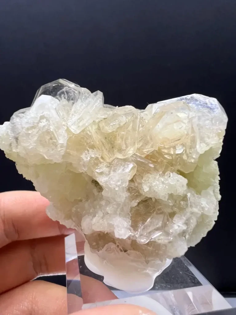 Fleshy pink hydroxyapophyllite crystals nestled among sparkling snow-white calcite micro-crystals.