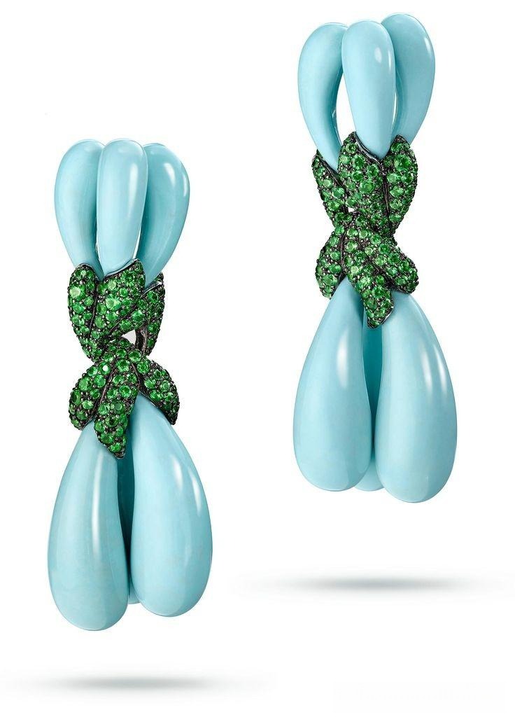 A pair of white gold earrings by de Grisogono set with sculpted turquoise, tsavorites, and diamonds.