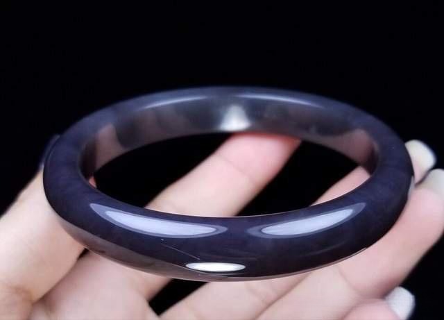 Deep, highly saturated smoky purple nephrite bangle with a striking dark violet-black hue.