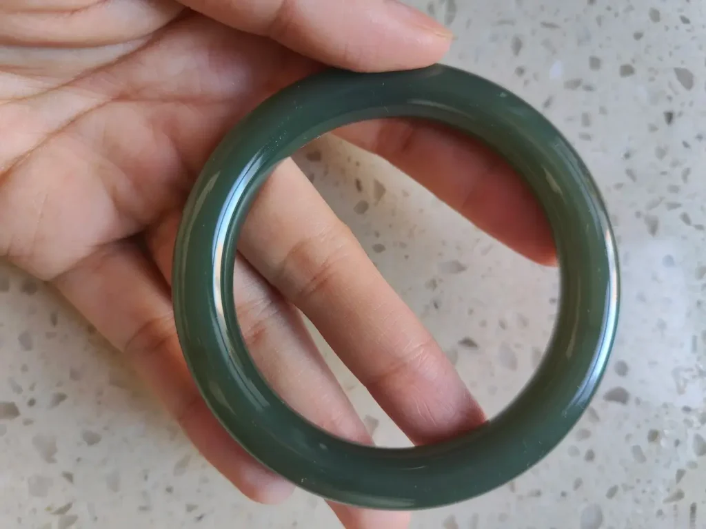 A flawless Duck Egg Green specimen, one of the cleanest Nephrite Jade varieties, in a structureless bangle.