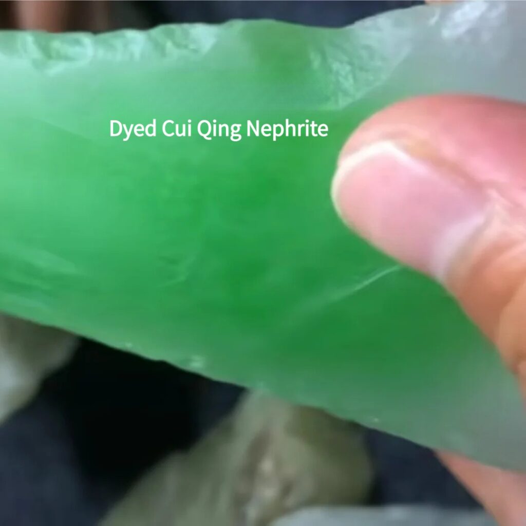 Close-up of dyed Cui Qing Nephrite showing unnatural color accumulation on the surface.