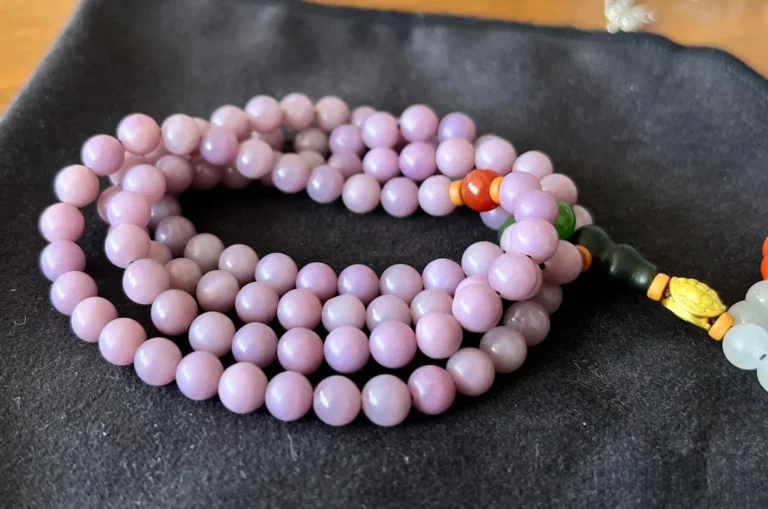 Dyed purple Hetian jade bead necklace with natural-looking white inclusions.