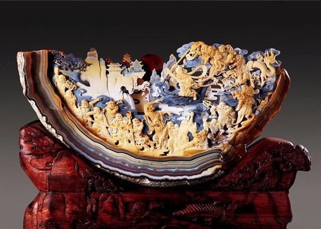 A finished Fuxin agate carving showcasing intricate details and natural color gradients.