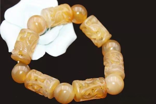 A polished Fuxin agate beaded bracelet from Liaoning, showing vibrant colors and fine texture.