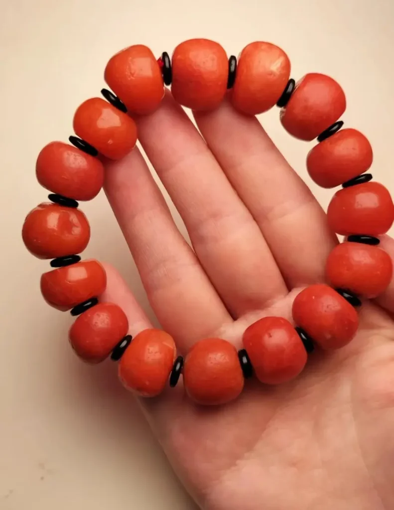 Gannan red agate bead bracelet from Gansu showing high saturation and vivid orange-red tones.
