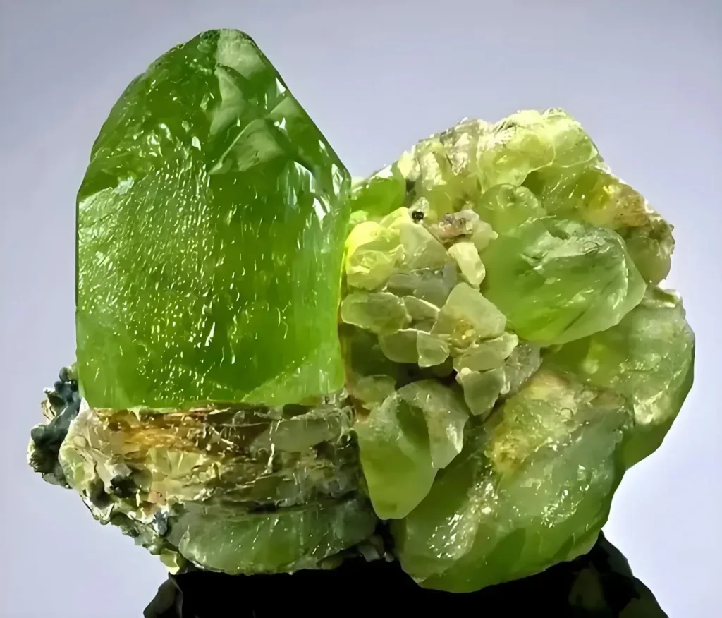 A large, transparent yellow-green peridot crystal specimen with high clarity and depth.
